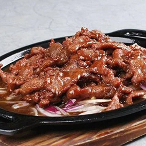 Sliced Beef with Onion on Hot Plate