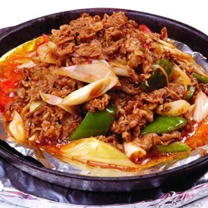 Sliced Lamb with Onion on Hot Plate