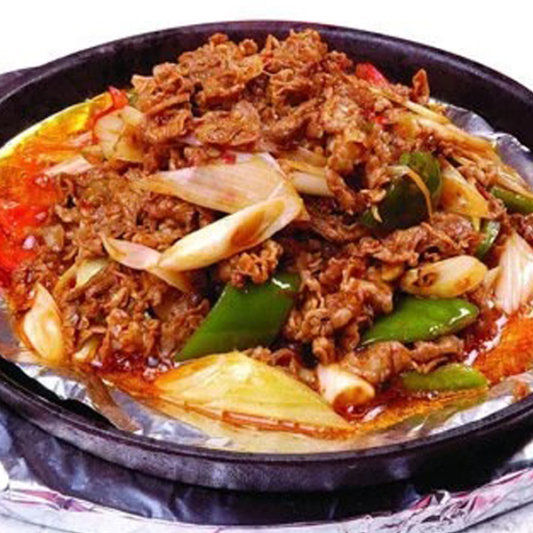 Sliced Lamb with Onion on Hot Plate
